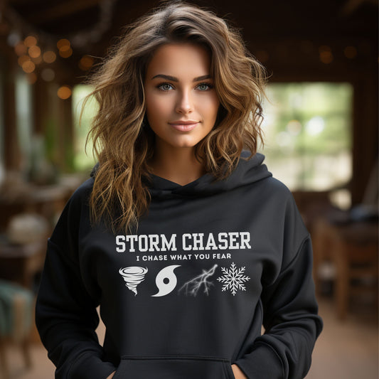 Storm Chaser Hooded Sweatshirt with "I Chase What You Fear" design, worn by a person indoors.