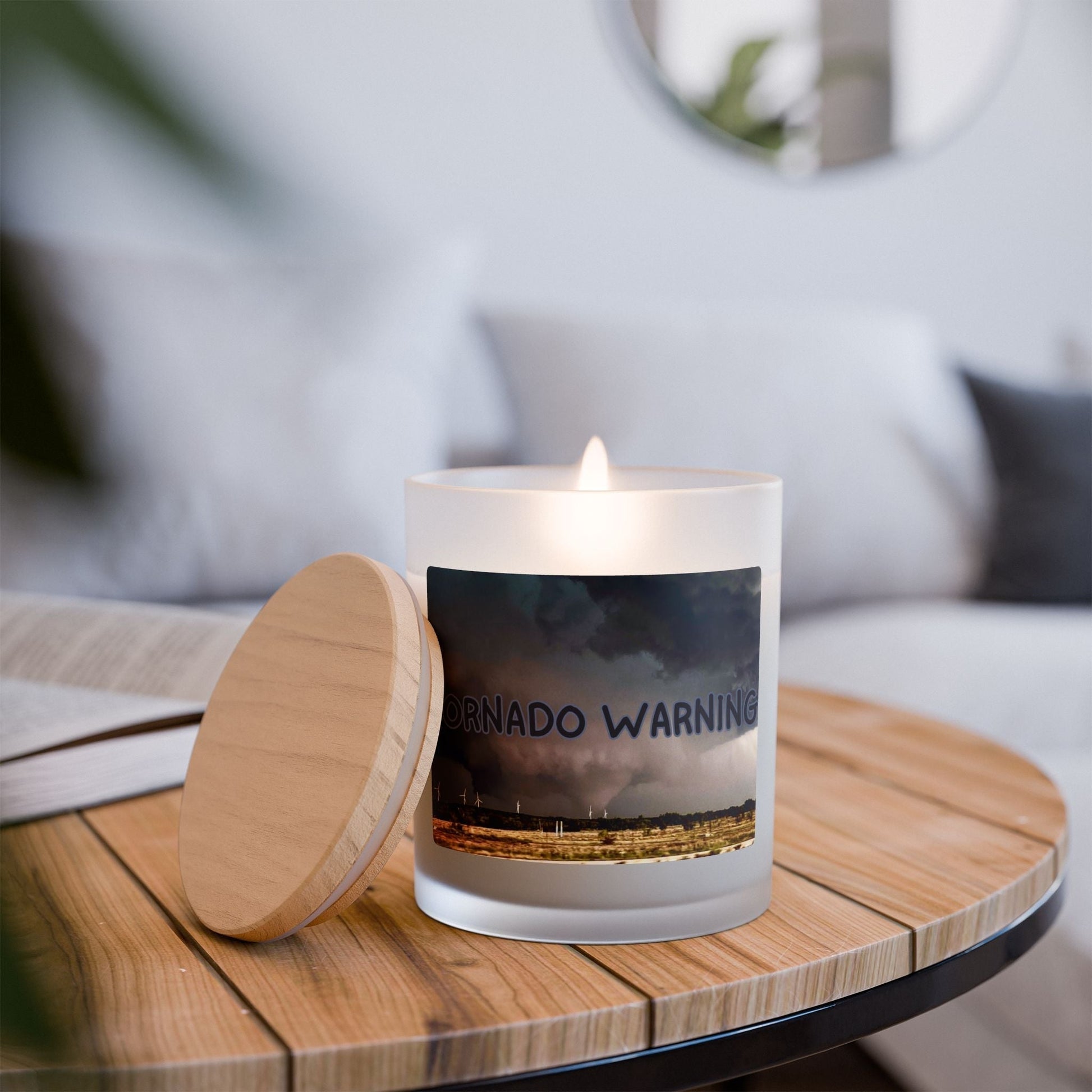 Frosted Glass Candle with Tornado Warning design on wooden table, lit for ambiance.
