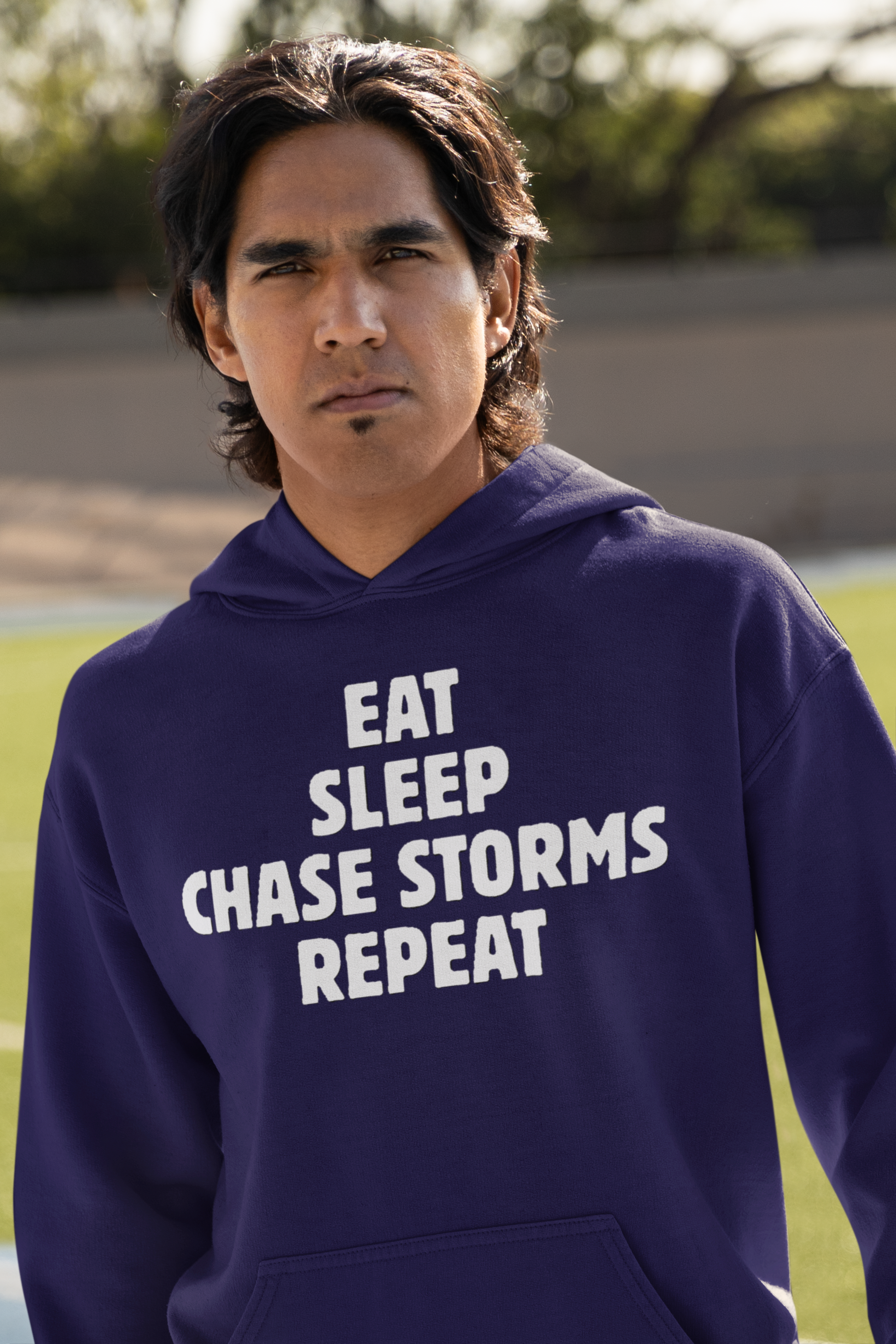 Hooded sweatshirt with "Eat Sleep Chase Storms Repeat" design.