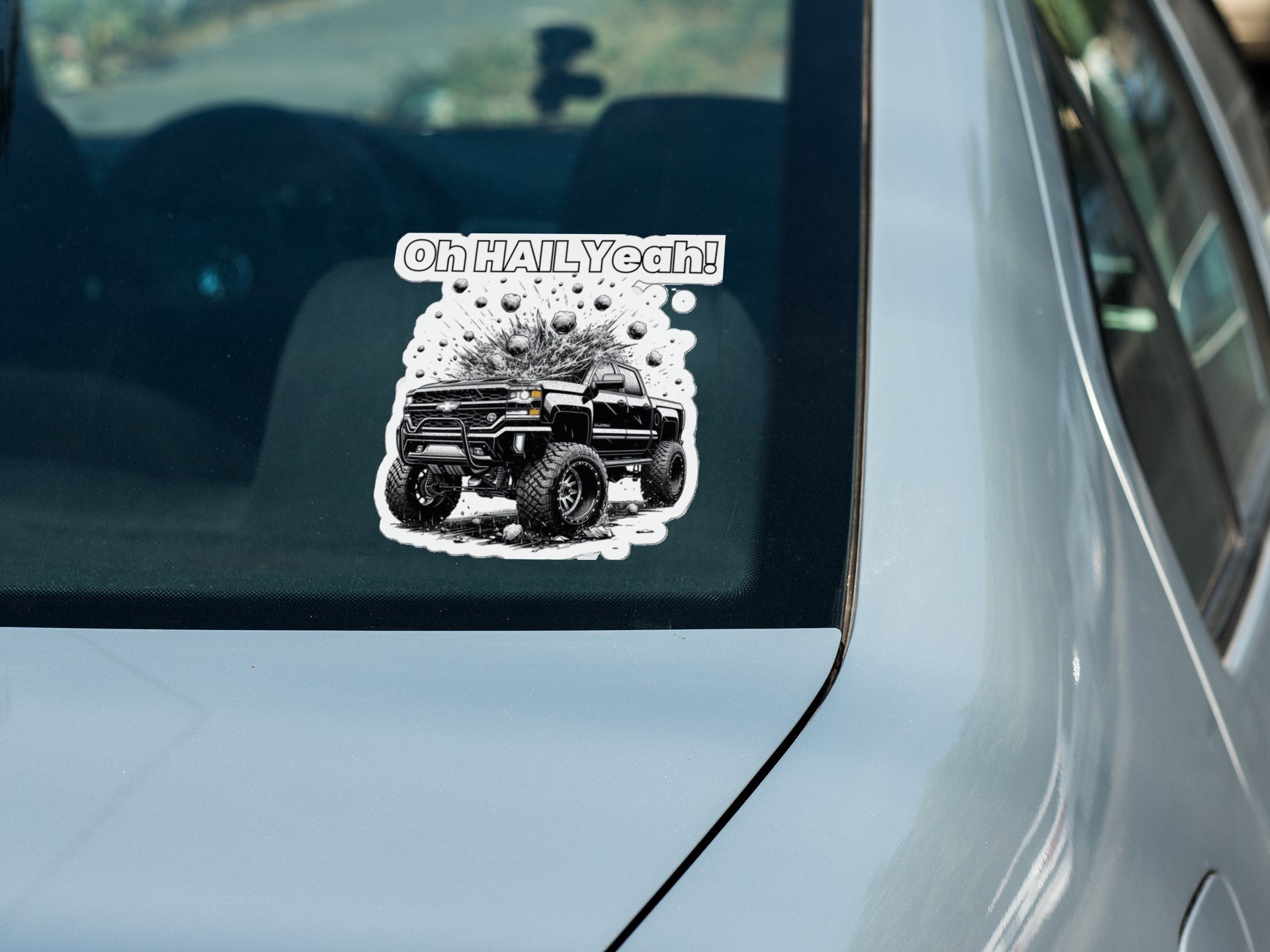 Storm Chaser custom die cut stickers on car window, featuring "Oh HAIL Yeah" graphic with a truck, ideal for weather enthusiasts.